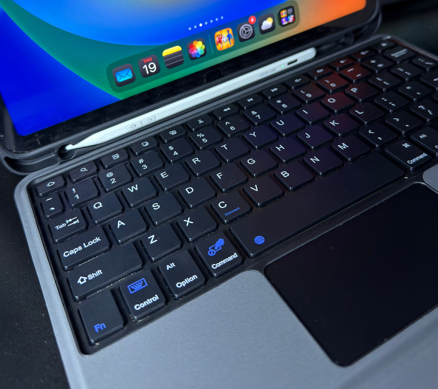 iPad keyboard case backlit keys close-up showing 7-color illuminated keyboard in low-light environment
